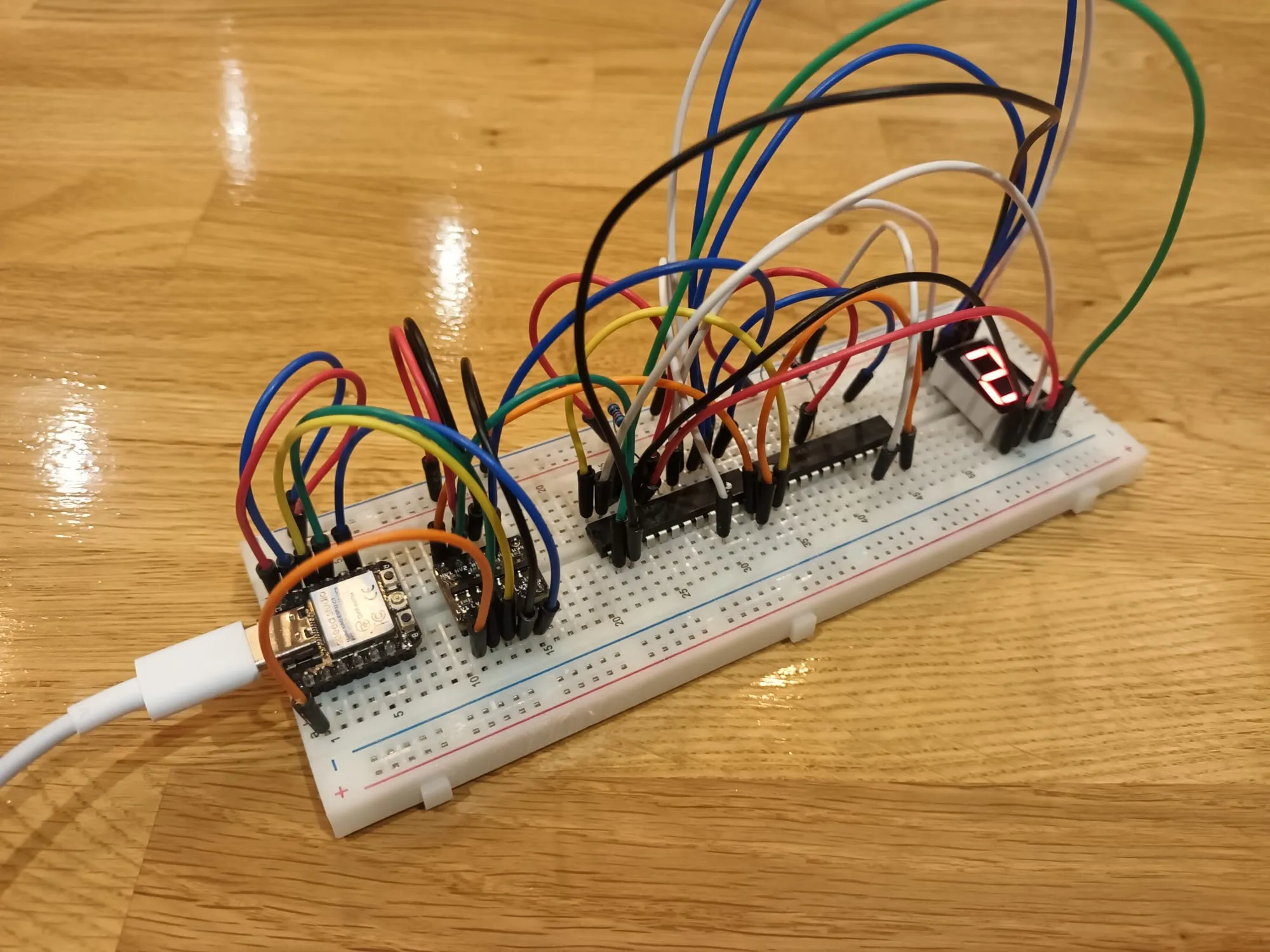 A breadboard with lots of wires and one 7-segment display